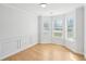 Spacious living room with hardwood floors, large windows, and classic molding at 1650 Willow River Run, Grayson, GA 30017