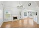 Bright living room featuring a fireplace, wood floors, high ceilings, and a stylish chandelier at 1650 Willow River Run, Grayson, GA 30017