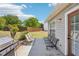 A concrete patio features chairs, a bench, and a grill at 1650 Willow River Run, Grayson, GA 30017
