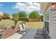 A concrete patio features chairs, a bench, and a grill at 1650 Willow River Run, Grayson, GA 30017