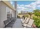 A concrete patio features chairs, a bench, and a grill at 1650 Willow River Run, Grayson, GA 30017