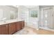 Bright bathroom with a double sink vanity, a bathtub and a walk-in shower at 3861 Sunbridge Dr, Snellville, GA 30039