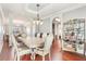 Elegant dining room with a chandelier, and an open view to the kitchen and living room at 3861 Sunbridge Dr, Snellville, GA 30039