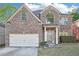 Charming brick home with a two-car garage and well-maintained landscaping at 3861 Sunbridge Dr, Snellville, GA 30039