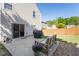 This is a backyard featuring a small patio, seating, flowers, a grill and a partial wood fence at 507 Oakleaf Ct, Acworth, GA 30102