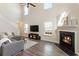 Bright living room features soaring ceilings, large windows, modern furniture, and fireplace at 507 Oakleaf Ct, Acworth, GA 30102