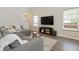 Bright living room features large windows, modern furniture, and modern television at 507 Oakleaf Ct, Acworth, GA 30102