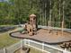 An inviting community playground featuring a slide and swing set in a fenced location at 507 Oakleaf Ct, Acworth, GA 30102