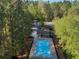 Aerial view of a refreshing community pool, surrounded by trees and offering a serene recreational space at 507 Oakleaf Ct, Acworth, GA 30102