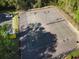 An aerial view of community tennis and basketball courts shows parking and mature trees at 507 Oakleaf Ct, Acworth, GA 30102