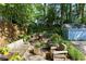 Cozy backyard featuring an outdoor living space with seating, lush greenery and mature trees at 777 Antone Nw St, Atlanta, GA 30318