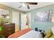 Bedroom featuring hardwood floors, a ceiling fan, dresser, and a large art piece at 777 Antone Nw St, Atlanta, GA 30318