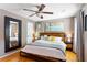 Bedroom with hardwood floors, ceiling fan, large bed and accent mirror at 777 Antone Nw St, Atlanta, GA 30318