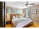 Bedroom with hardwood floors, ceiling fan, and large bed with stylish linens at 777 Antone Nw St, Atlanta, GA 30318