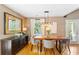 Bright dining area featuring hardwood floors, a wooden table, and a decorative mirror, perfect for entertaining at 777 Antone Nw St, Atlanta, GA 30318
