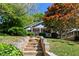 Charming home exterior with stone steps, covered porch, and beautiful landscaping at 777 Antone Nw St, Atlanta, GA 30318