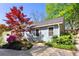 Exterior view of the home showcasing mature landscaping, a beautiful red maple, and a well-maintained yard at 777 Antone Nw St, Atlanta, GA 30318