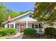 Charming single-story home featuring light blue siding, a red front door, and a well-maintained landscaped yard at 777 Antone Nw St, Atlanta, GA 30318