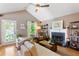 Inviting living room featuring a fireplace, hardwood floors, comfortable seating, and access to the outdoors at 777 Antone Nw St, Atlanta, GA 30318