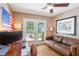 Office featuring hardwood floors, a ceiling fan, computer desk, leather sofa and french doors to patio at 777 Antone Nw St, Atlanta, GA 30318