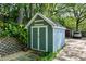 Neat backyard storage shed with double doors, light blue siding and a gray roof at 777 Antone Nw St, Atlanta, GA 30318