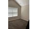 This bedroom has vaulted ceilings, a window that lets in light, and carpeted floors at 220 Rehobeth Way, Fayetteville, GA 30214