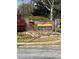 Stone sign for The Villas at Gingercake community with colorful landscaping and stone wall at 220 Rehobeth Way, Fayetteville, GA 30214