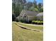 Charming one-story home featuring manicured lawn, lush shrubbery, and elegant arched windows at 220 Rehobeth Way, Fayetteville, GA 30214
