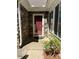 Inviting front entrance showcasing a red door, stone accents, and stylish exterior lighting at 220 Rehobeth Way, Fayetteville, GA 30214