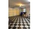 Spacious two-car garage featuring a striking black and grey diamond-patterned floor at 220 Rehobeth Way, Fayetteville, GA 30214