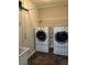 Well-lit laundry area features a front load washer and dryer set with overhead shelving at 220 Rehobeth Way, Fayetteville, GA 30214
