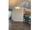 Open living area with wood floors, tall ceilings, decorative lighting and kitchen access at 220 Rehobeth Way, Fayetteville, GA 30214