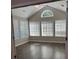 Bright living room features vaulted ceilings, large windows, and new wood-look flooring at 220 Rehobeth Way, Fayetteville, GA 30214