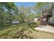 Large backyard with green grass, mature trees, and a detached shed at 278 Benjamin Dr, Rockmart, GA 30153