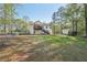 Extensive backyard featuring mature trees, a two-story home with a deck, and a fenced perimeter at 278 Benjamin Dr, Rockmart, GA 30153