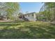 Expansive, level backyard featuring mature trees and a two-story home with a deck at 278 Benjamin Dr, Rockmart, GA 30153