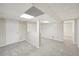 Finished basement with neutral carpet and paneled walls leading to a separate area at 278 Benjamin Dr, Rockmart, GA 30153