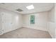 Spacious basement featuring neutral carpet, wood paneling, and a bright window at 278 Benjamin Dr, Rockmart, GA 30153
