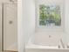Bright bathroom featuring a separate shower and a soaking tub with large window at 278 Benjamin Dr, Rockmart, GA 30153