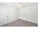 Bedroom with two doors, carpet flooring, white walls and trim, and a ceiling fan at 278 Benjamin Dr, Rockmart, GA 30153