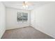 Neutral bedroom with a ceiling fan, carpet flooring, a large window, and white trim at 278 Benjamin Dr, Rockmart, GA 30153