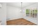 Charming dining area with wood-look flooring, modern chandelier, and large windows with backyard views at 278 Benjamin Dr, Rockmart, GA 30153