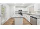 Modern kitchen featuring white cabinets, stainless steel appliances, granite countertops, and wood-look floors at 278 Benjamin Dr, Rockmart, GA 30153