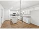 Modern kitchen featuring white cabinets, granite countertops, stainless steel appliances, and wood-look floors at 278 Benjamin Dr, Rockmart, GA 30153