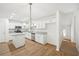 Beautiful kitchen features white cabinetry, stainless steel appliances, granite counters, and wood-look floors at 278 Benjamin Dr, Rockmart, GA 30153