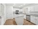 Modern kitchen featuring white cabinets, stainless steel appliances, granite countertops, and wood-look floors at 278 Benjamin Dr, Rockmart, GA 30153