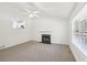 Bright living room featuring a fireplace, ceiling fan, and a large window at 278 Benjamin Dr, Rockmart, GA 30153