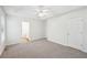 Spacious main bedroom featuring a tray ceiling, carpet flooring, and a ceiling fan at 278 Benjamin Dr, Rockmart, GA 30153