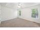 Spacious main bedroom boasts tray ceiling, ceiling fan, and two windows overlooking wooded backyard at 278 Benjamin Dr, Rockmart, GA 30153
