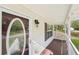Covered porch with paneled ceiling and oval glass front door at 278 Benjamin Dr, Rockmart, GA 30153